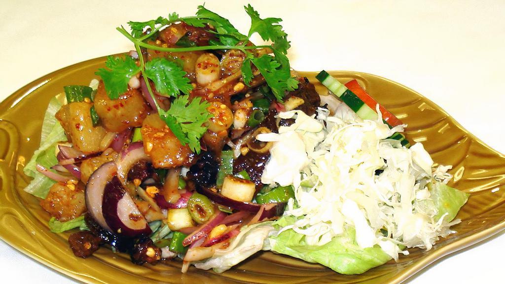 Duck Salad · Nut. Soy sauce, gluten, wheat. Mild Spicy. Sliced of duck / ginger / red onion / scallion / pineapple / ground peanut / chili & lime juice / on the bed of lettuce