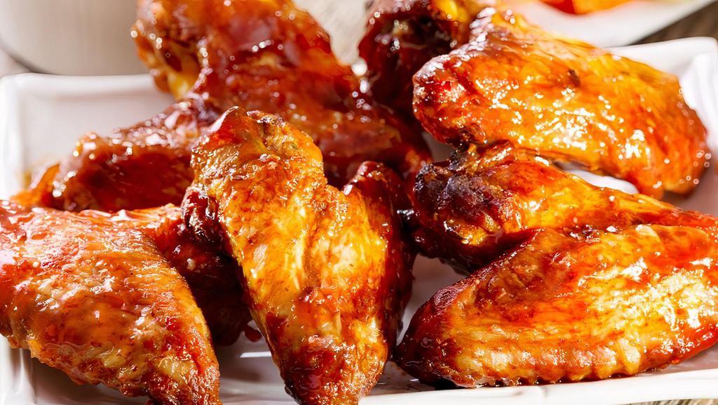 Chicken Wings · Tossed in buffalo or BBQ sauce and served with blue cheese, celery & carrots.