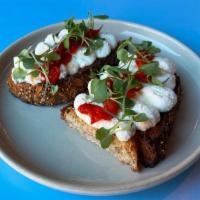 Ricotta Toast · With herbed salt, pickled pepper, microgreens and garlic olive oil. Served on seeded sourdou...