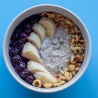 Overnight Oats · Coconut, banana, maple, apples and golden raisins. Topped with fruit compote and candied see...
