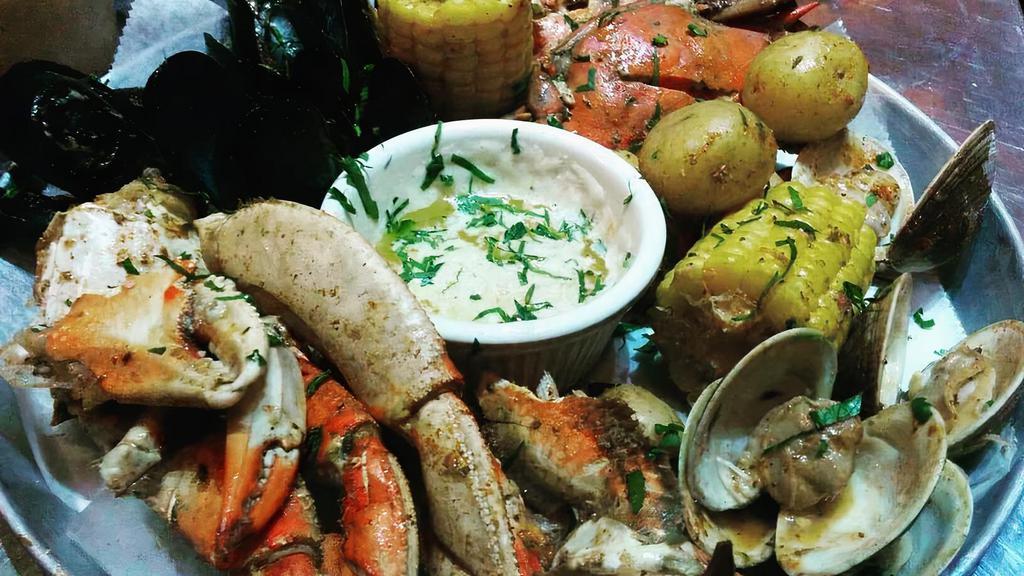 Oth Crab Boil · steamed snow crab & mixed seafood, tossed in cajun spices, served w/ side of rice and argentinian sausage