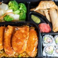 Salmon Bento · Served with mixed vegetable, white rice, plus 4 pcs California Roll, 2 pcs chicken dumplings...