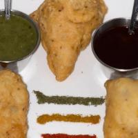 Vegetable Samosa (Three Pieces) · Deep-fried pastry with savory potato and cauliflower filling, served with mint and tamarind ...