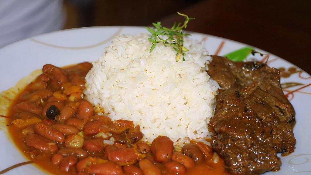 Beef Stew · Sliced beef slows cooked with mixed vegetables and fresh herbs. Served with rice, beans, and plantains.