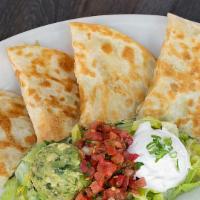 Chiken Quesadilla · Flour tortilla filled with trio cheese, dice chicken, served with guacamole and sour cream