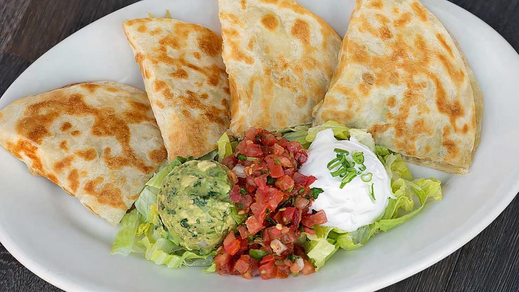 Steak Quesadilla · four tortilla filled with trio cheese, dice chicken, served with guacamole, and sour cream