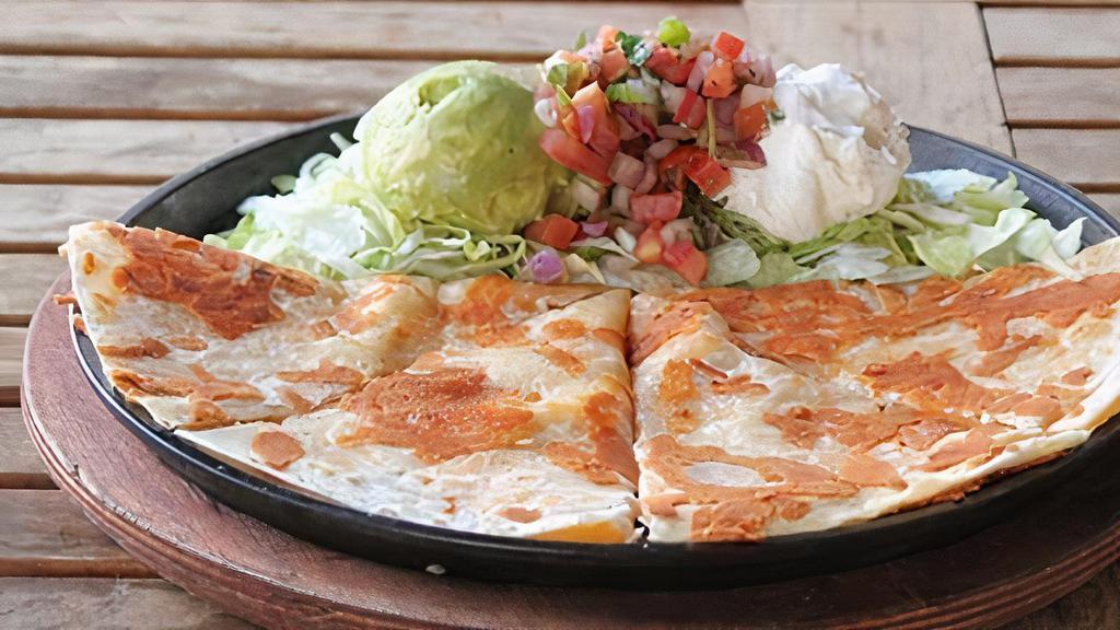 Cheese Quesadilla  · flour tortilla, filled with trio cheese, served with guacamole and sour cream