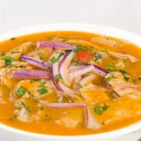 Fish Encebollado · Typical Ecuadorian dish of tuna fish stew with yuka, toasted corn and onions, served with ri...