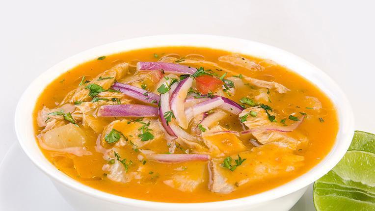 Fish Encebollado · Typical Ecuadorian dish of tuna fish stew with yuka, toasted corn and onions, served with rice.