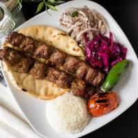 Adana Kebab (Lamb Kebab) · Ground lamb flavored with red bell pepper and paprika. Served with pita bread, grilled veget...