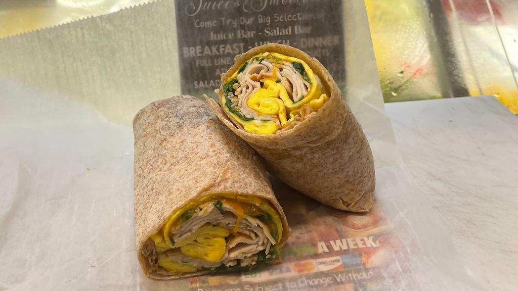 Canadian Breakfast Wrap · Warm wrap stuffed with sliced boar's head blackened turkey, fluffy scrambled eggs, spinach and melted cheddar cheese.