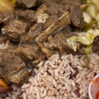 Curry Goat · Served with White Rice, Peas & Rice, Cabbage, Plantains.
