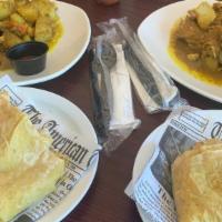  Curry Goat  Roti   · Curry goat with buss up shot or Dhalpuri
