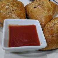 Samsa (1 Piece) Homemade · Traditional buttery flaky pastry dough is wrapped around finely minced lamb meat filling soa...