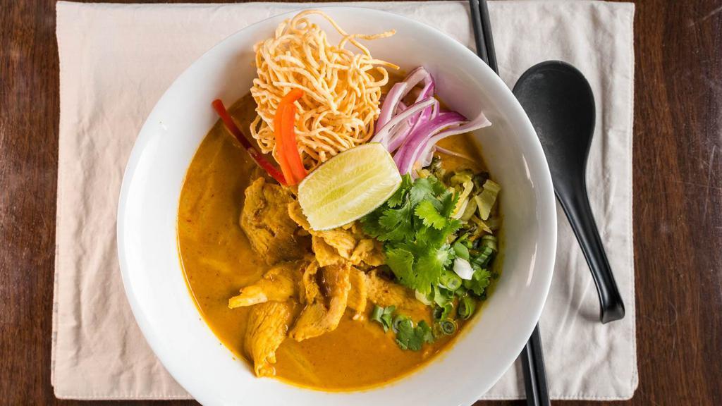 Chicken Chiang Mai Noodle · Red onions, lime, scallions, pickled cabbages, bean sprouts in a light yellow curry broth, topped with crispy yellow noodles.