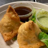 Samosa · Pastry turnovers, spiced potatoes and green peas. Served with a fresh mint   &  Sweet dates ...