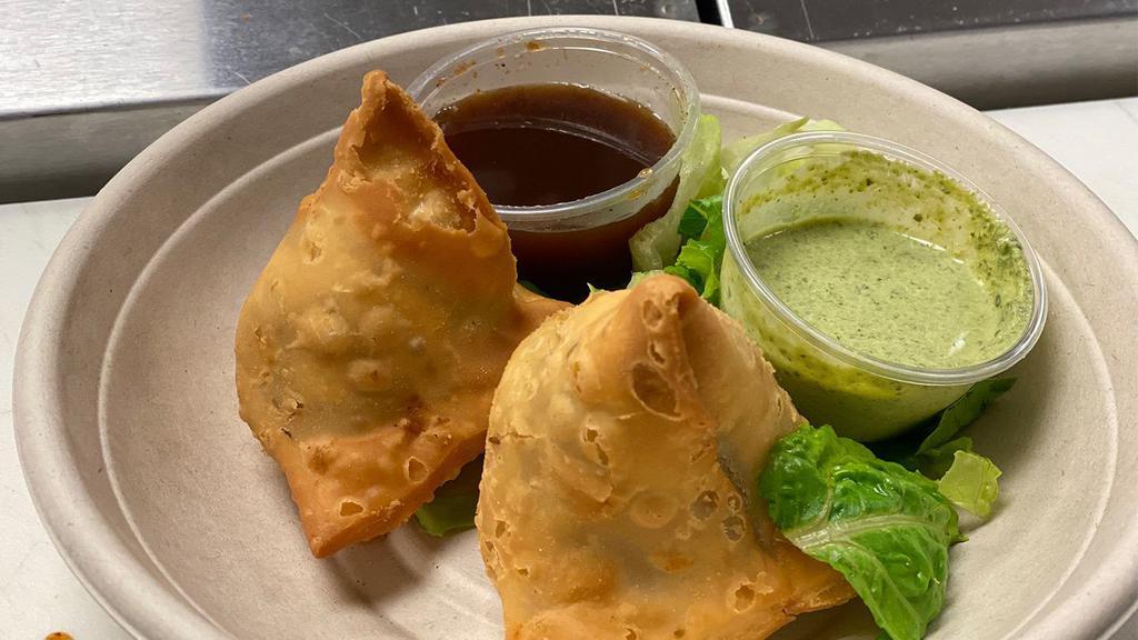 Samosa · Pastry turnovers, spiced potatoes and green peas. Served with a fresh mint   &  Sweet dates chutney. Vegan.
