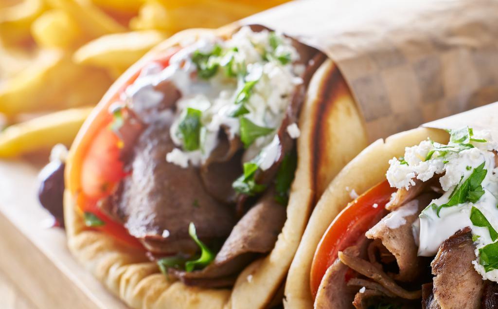 Gyro Sandwich · Beef & lamb gyro with seasonings and grilled to perfection. Filled with chopped salad, and drizzled with the famous white sauce.