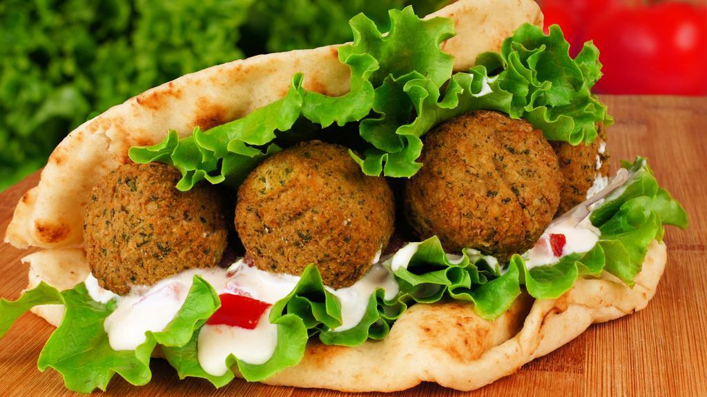 Falafel Sandwich · Our house-made falafel are made of ground chickpeas, jalapeno, onion, cilantro and seasonings lightly fried. Filled with chopped salad, and drizzled with tahini.