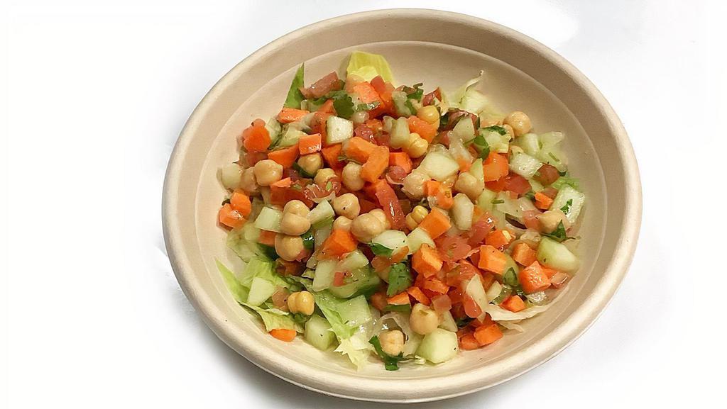 Kachumber Salad · Diced carrots, cucumbers, tomato, cilantro, and chickpeas in a fresh lemon vinaigrette dressing