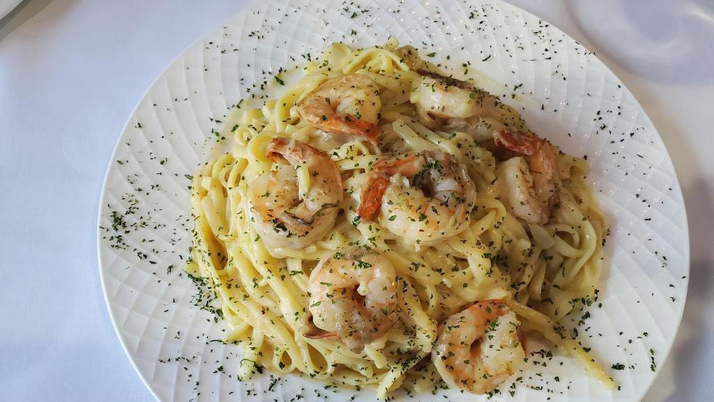 Shrimp Scampi · Over linguini pasta.