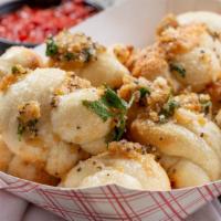 Garlic Knots · Warm knots topped with a garlic sauce and served with marinara sauce.