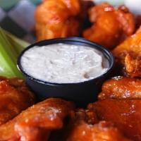 Chicken Wings 12 Pcs  · Un-breaded chicken wings, baked then basted with your choice of sauce, served with celery an...