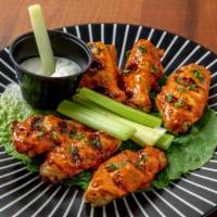 Chicken Wings 6 Piece · Un-breaded chicken wings, baked then basted with your choice of sauce*, served with celery a...