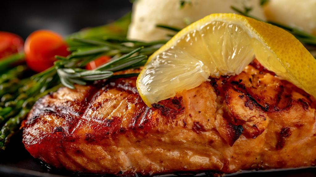 Grilled Salmon · Salmon Fillet is grilled until perfectly golden brown then covered in simple, vibrant and rich lemon butter sauce served with mashed potato and sauteed vegetables