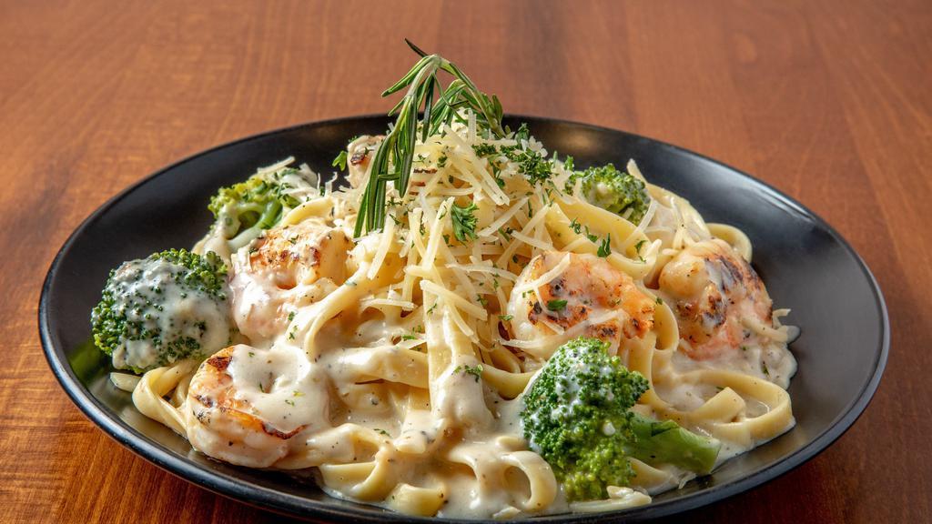 Shrimp Alfredo Pasta · Indulge in the cheesiness of our shrimp pasta, cooked in a rich, creamy, cheese sauce, tossed with broccoli and garnished with parmesan and parsley.