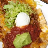 Super Nachos · Happy hour item. Corn tortilla chips with our homemade chili, lettuce, salsa, homemade guaca...