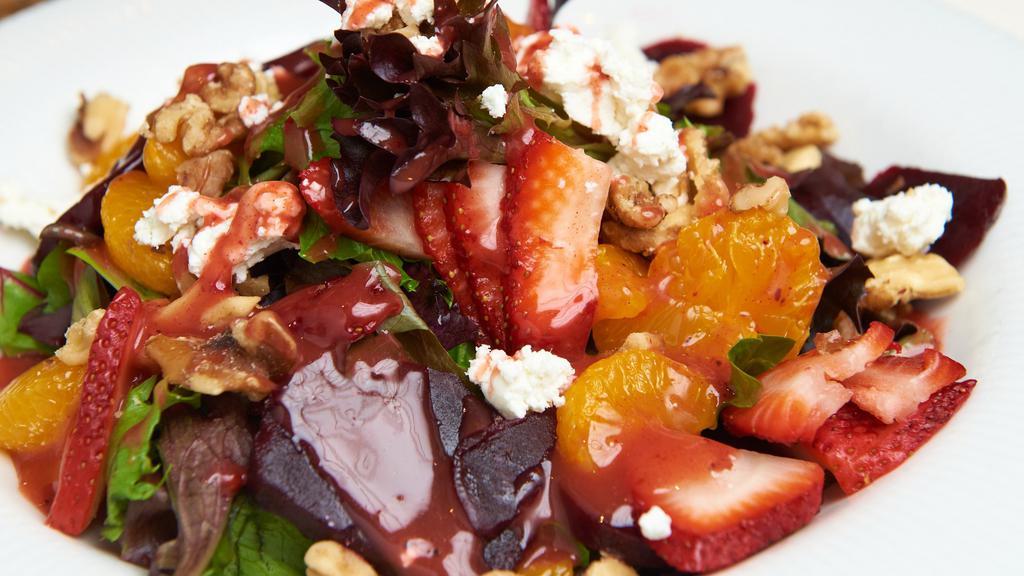 Beet Goat Cheese Salad · Tossed mesclun greens, baby spinach, sliced strawberries, beets, walnuts, mandarin segments, crumbled goat cheese and our homemade strawberry balsamic dressing