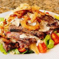Steakhouse Salad · Grilled sliced steak, romaine lettuce, cherry tomatoes, onions, corn tortilla chips, and blu...
