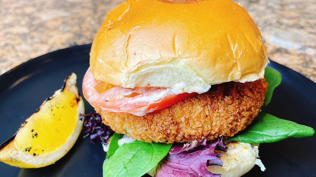 Crab Cake Sandwich · Homemade pan-fried crab cake with lettuce, tomatoes, and a lemon remoulade sauce on a brioche bun