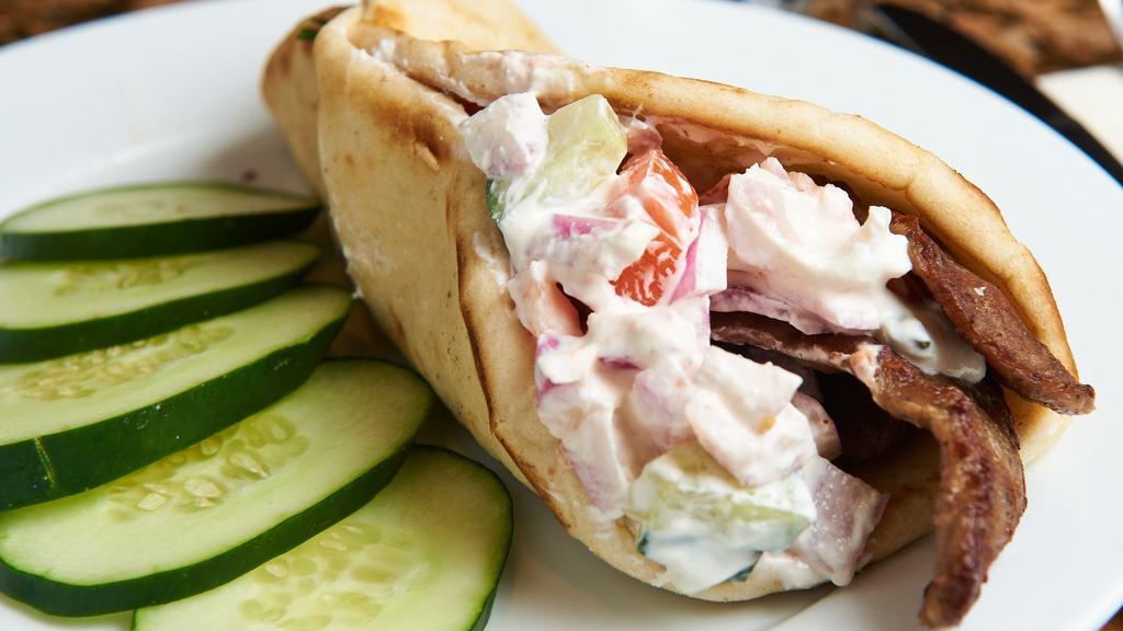 Lamb Gyro · Roasted lamb, tomatoes, onions, cucumbers and tzatziki sauce in a warm pita Chicken substitution available