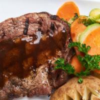 Grilled Rib-Eye Steak · Grilled fresh herb marinated 12 oz. T-Bone steak served with a red wine demi-glace and seaso...