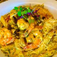 Cajun Rasta Pasta · Stir fried chicken, shrimp, onions, bell peppers, and sundried tomatoes in a cajun sauce ove...