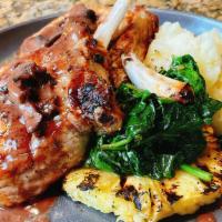 French Cut Pork Chops · Sautéed French cut pork chops with sautéed spinach, grilled pineapples, whipped potatoes, an...