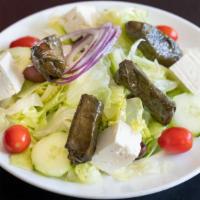 Mediterranean Salad · Dolmades, lettuce, crumbled feta, kalamata olives, tomatoes, cucumbers, onions & greek vinai...