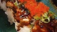 Godzilla Roll · Salmon, tuna, yellow tail, and masago, deep fried with eel sauce and spicy mayonnaise.