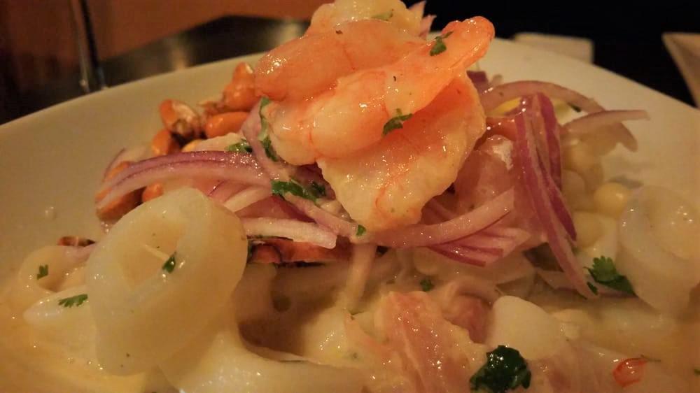 Ceviche Mixto · Catch of the day , jumbo shrimp, calamari rings, and sliced octopus marinated in lime juice and our signature 