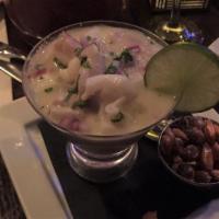 Leche De Tigre · A mini fish and calamari ceviche style concentrate. The best of a ceviche served in a martin...