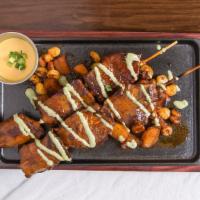Anticucho Classico · A staple in Peruvian street food: beef heart kebabs served with seasoned roasted potato and ...