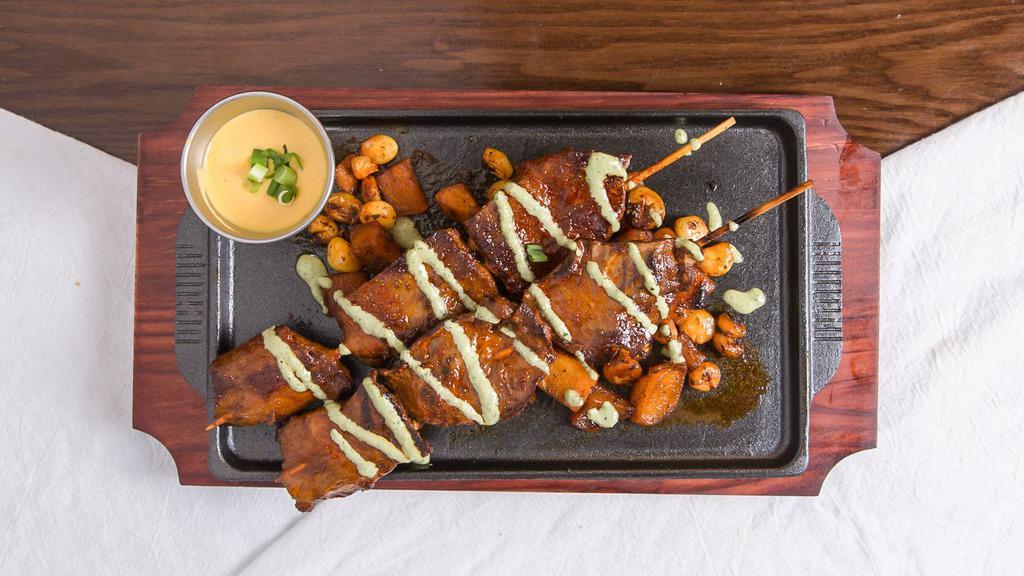 Anticucho Classico · A staple in Peruvian street food: beef heart kebabs served with seasoned roasted potato and Peruvian corn