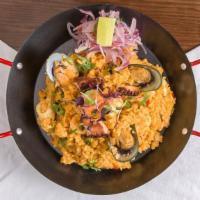 Arroz Con Mariscos · Our paella style rice is simmered with dark beer, saffron, and house-made stocks. Made with ...