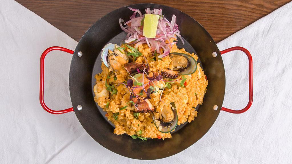 Arroz Con Mariscos · Our paella style rice is simmered with dark beer, saffron, and house-made stocks. Made with jumbo shrimp, calamari rings , scallops, sliced octopus, and mussels. Served with salsa criolla