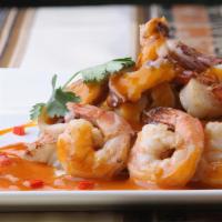 Pescado A Lo Macho · A chef recommendation! Grilled grouper fillet, topped with a seafood sauce of jumbo shrimp, ...