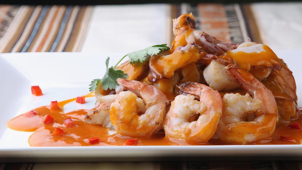Pescado A Lo Macho · A chef recommendation! Grilled grouper fillet, topped with a seafood sauce of jumbo shrimp, calamari, scallops, and sliced octopus
