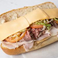 All American · Ham, roasted beef, turkey, American cheese lettuce, tomato, & pickles.