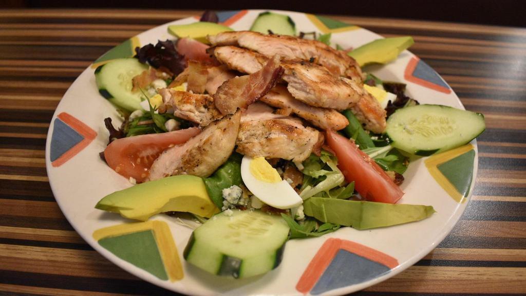 Cobb Salad · Grilled chicken breast, avocado, blue cheese, bacon, hard boiled egg, cucumber & tomato, over mixed greens with choice of dressing.